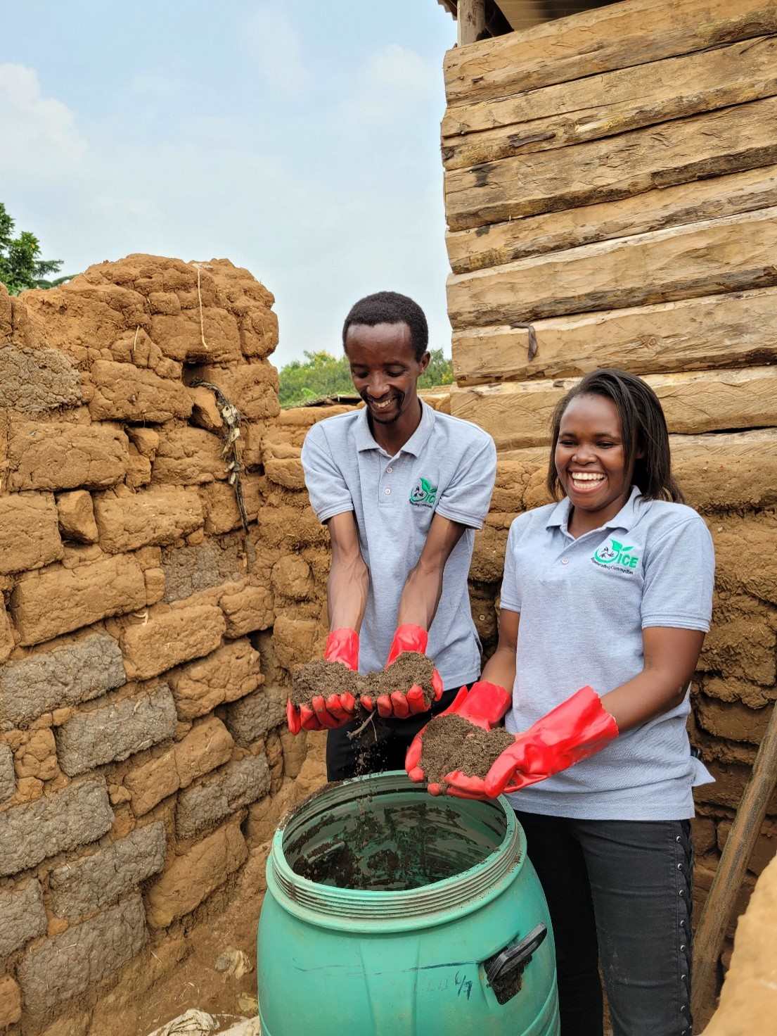 Aimable and Winnie show the fertile earth farmers can get from their compost toilet solution Ecosan in a settlement’s household