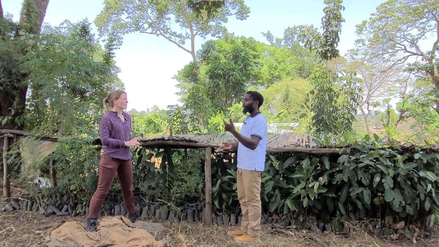 Tina Teucher and Bemeriki Bisimwa Dusabe standing at the tree nursery of the permaculture garden in Rwamwanja refugee settlement, Uganda.