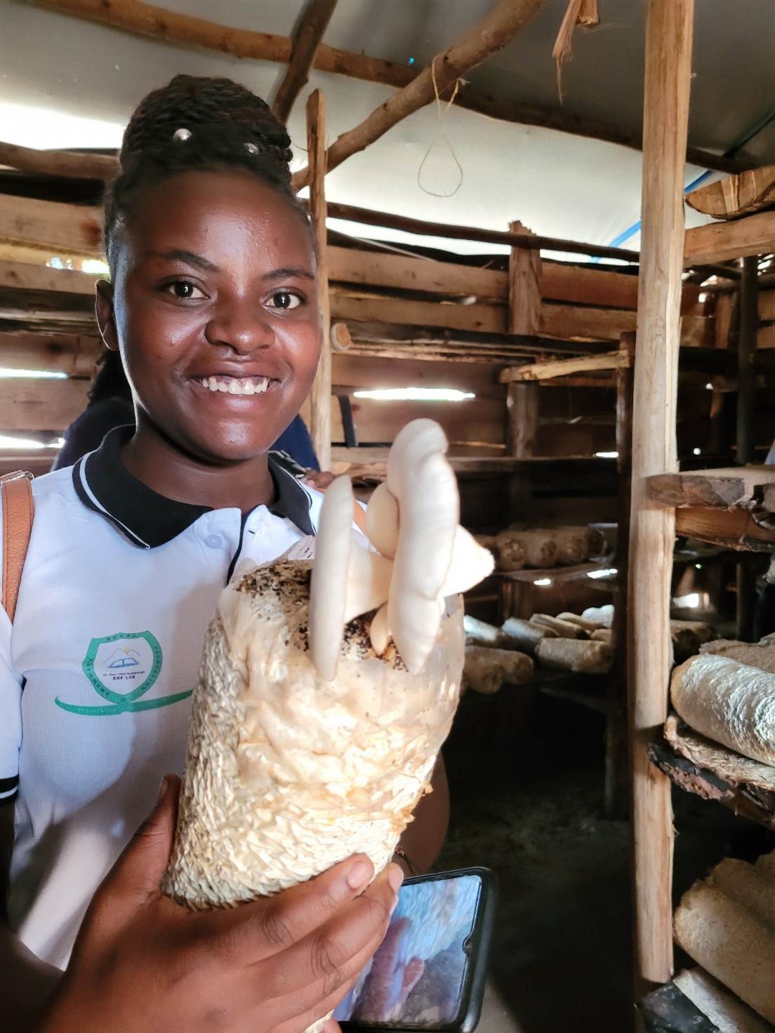 Jackline from the Rwamwanja Rural Foundation team showing mushroom production