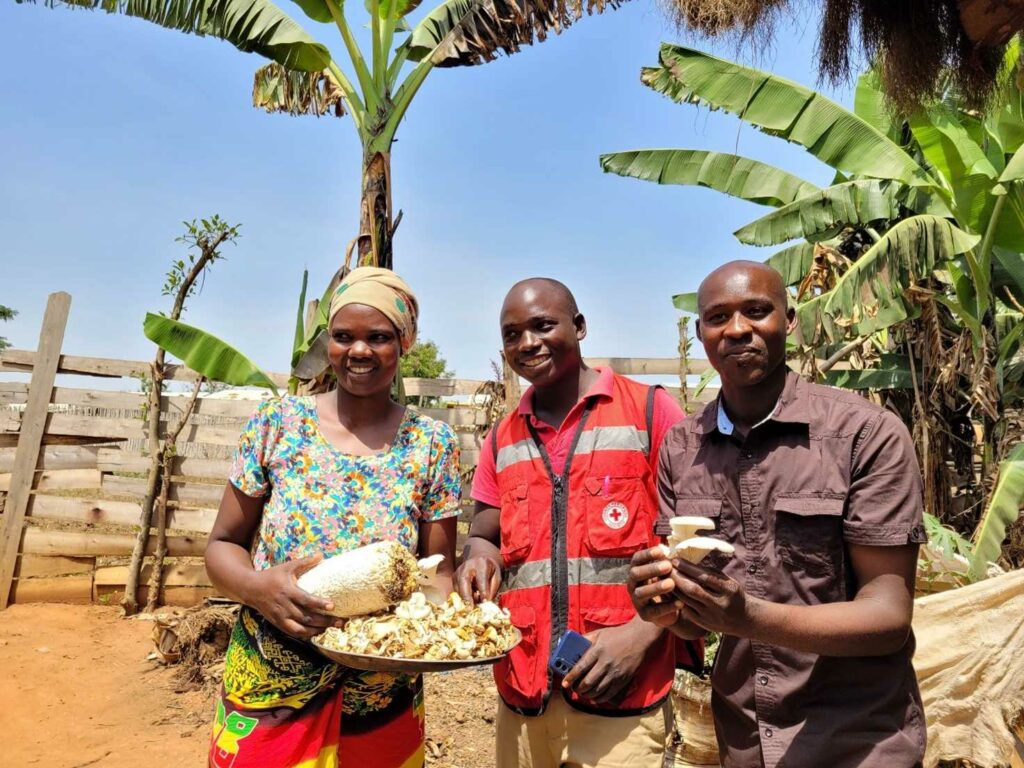 three people from mushroom production group trained by Rwamwanja Rural Foundation in Rwamwanja refugee settlement in Uganda