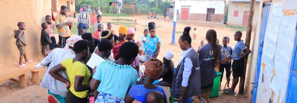 women and children watchen a soap production course in Uganda, Africa