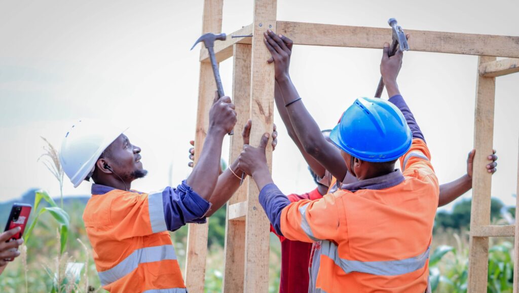 Refugee men supporting their community by constructing composting toilets to improve hygiene