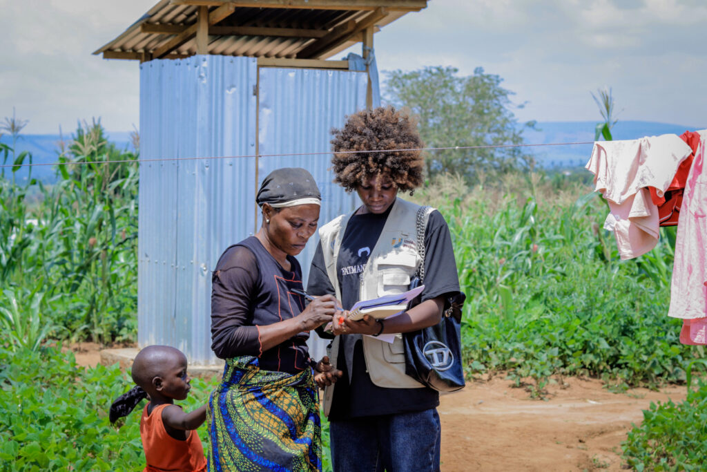 Refugees supporting refugees by sharing knowledge on how to use a composting toilet