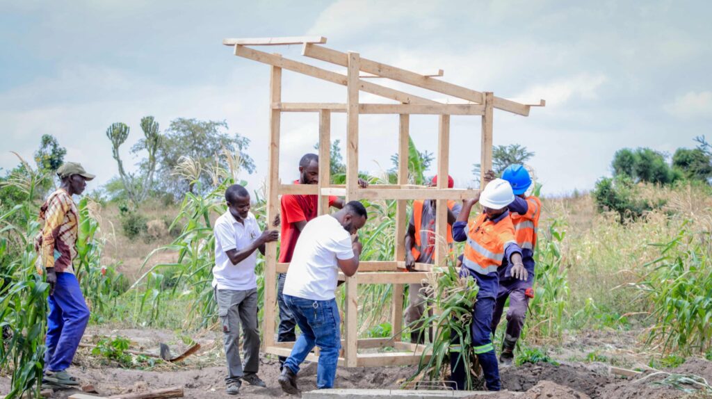 Refugees constructing a compost toilet together